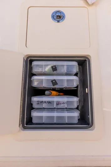  Yacht Photos Pics Storage compartment on 2022 Grady-White Canyon 336 boat with organized tackle boxes.