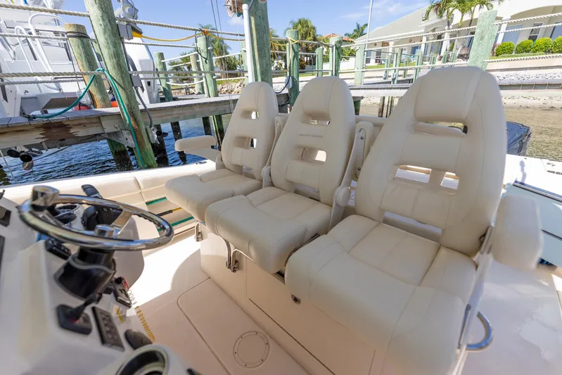  Yacht Photos Pics 2022 Grady-White Canyon 336 boat with luxurious helm seating at a marina.