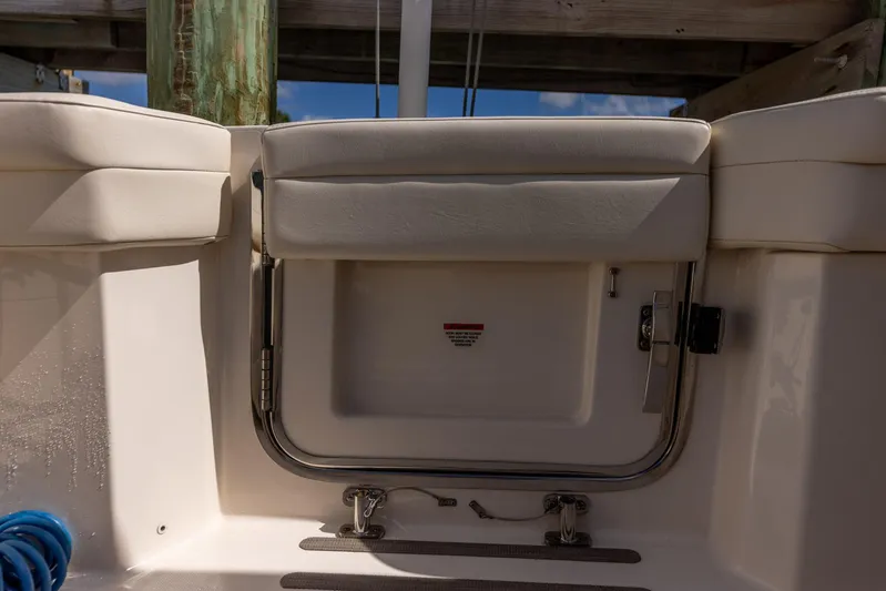  Yacht Photos Pics 2022 Grady-White Canyon 336 boat interior with cushioned seating and storage compartment.