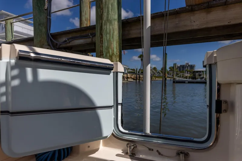  Yacht Photos Pics 2022 Grady-White Canyon 336 boat docked by a serene waterfront.