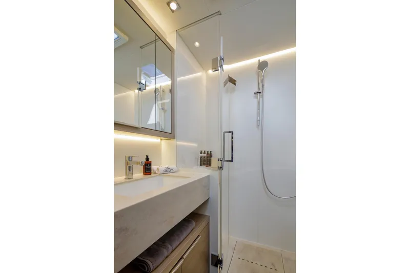  Yacht Photos Pics Modern bathroom in 2023 Lagoon 55 yacht with sleek shower and vanity.