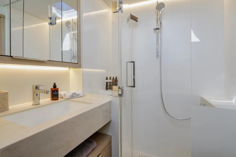  Yacht Photos Pics Luxurious bathroom in 2023 Lagoon 55 yacht with modern fixtures and elegant design.