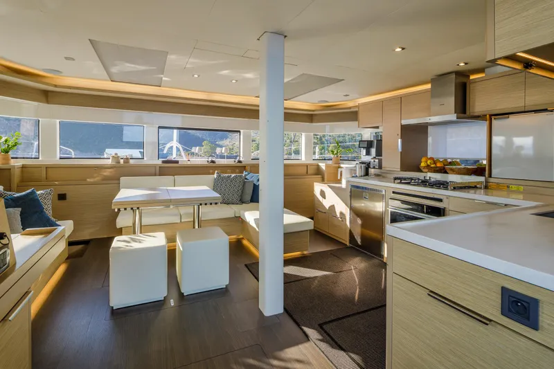  Yacht Photos Pics Luxurious interior of 2023 Lagoon 55 yacht with modern kitchen and dining area.