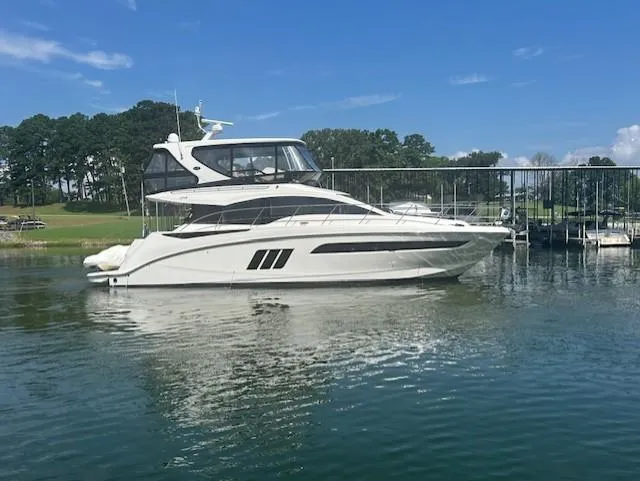 Yonder Star Yacht Photos Pics 2016 Sea Ray 510 Fly yacht on calm water, docked near a marina.
