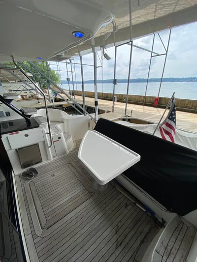 Yonder Star Yacht Photos Pics 2016 Sea Ray 510 Fly yacht deck with seating, table, and American flag.