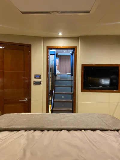 Yonder Star Yacht Photos Pics Interior of 2016 Sea Ray 510 Fly yacht, featuring a cozy cabin with stairs and a TV.