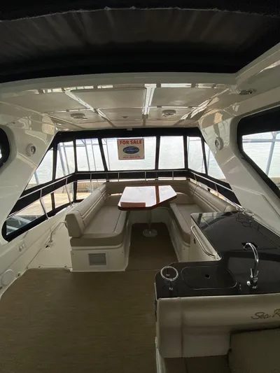 Yonder Star Yacht Photos Pics Interior of 2016 Sea Ray 510 Fly yacht with seating and table, "For Sale" sign visible.