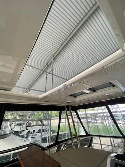 Yonder Star Yacht Photos Pics Interior view of 2016 Sea Ray 510 Fly yacht with sunroof and marina backdrop.