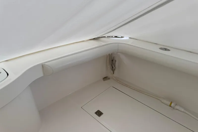 Regalo Yacht Photos Pics 2013 Cabo 44 Hardtop Express interior detail, featuring sleek white surfaces and storage compartment.