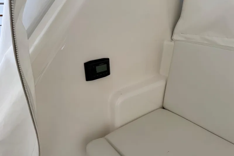 Regalo Yacht Photos Pics Interior of 2013 Cabo 44 Hardtop Express with white seating and control panel.