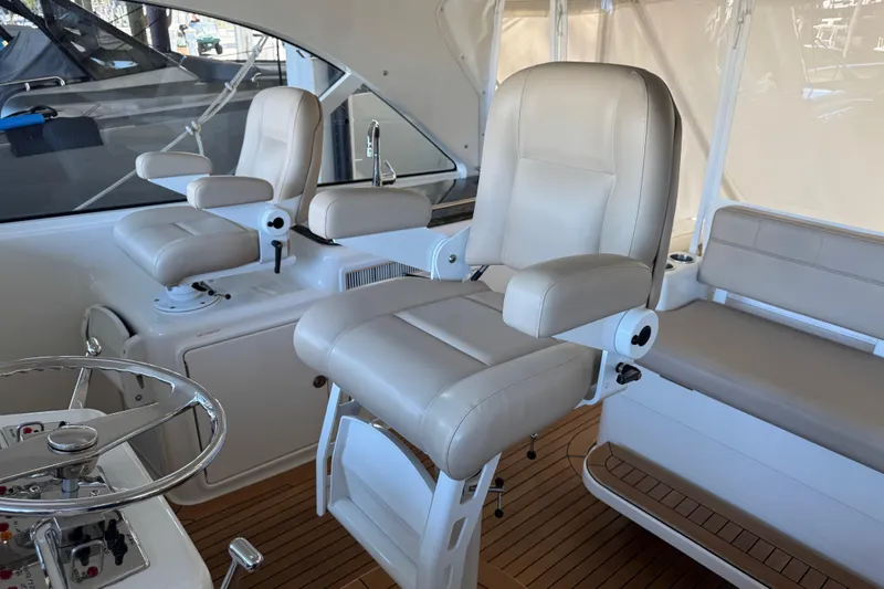 Regalo Yacht Photos Pics Luxurious interior of 2013 Cabo 44 Hardtop Express yacht with plush seating and steering wheel.