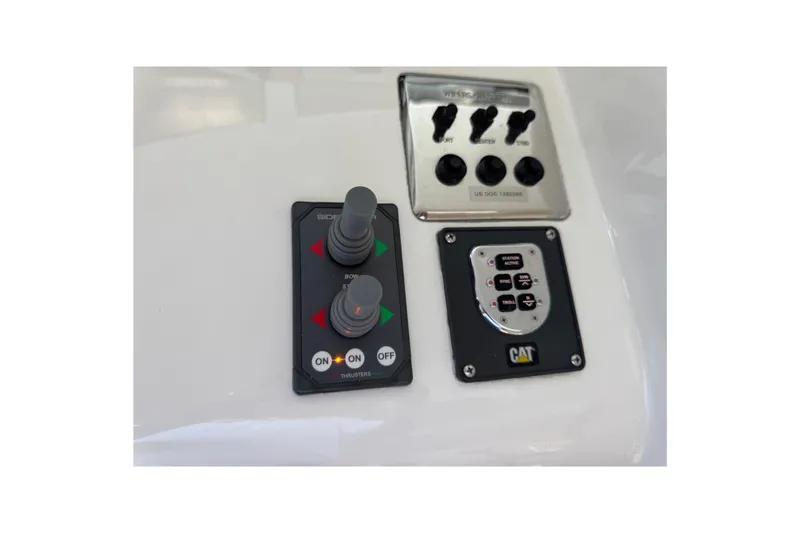 Regalo Yacht Photos Pics Control panel of a 2013 Cabo 44 Hardtop Express boat with joysticks and switches.