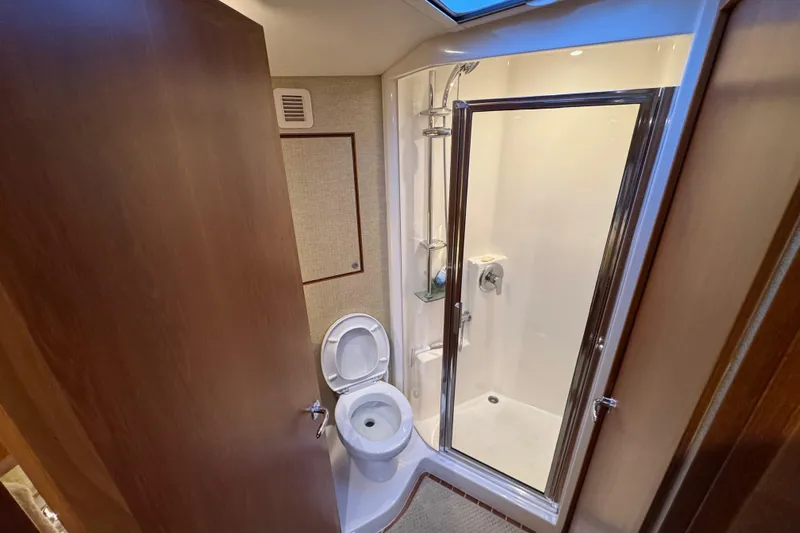 Regalo Yacht Photos Pics Bathroom interior of 2013 Cabo 44 Hardtop Express yacht with shower and toilet.