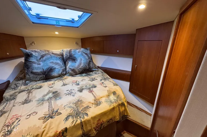 Regalo Yacht Photos Pics 2013 Cabo 44 Hardtop Express cabin with cozy bed and tropical decor.