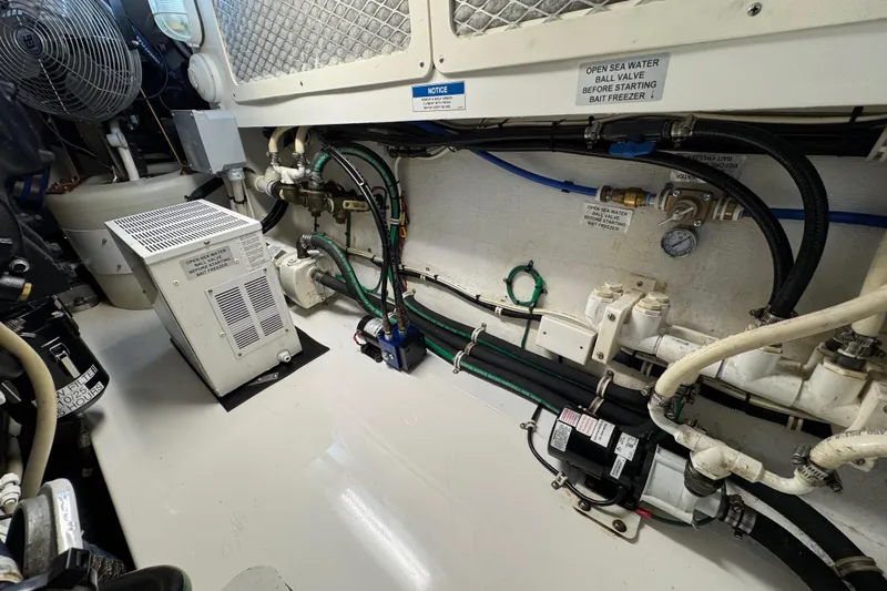 Regalo Yacht Photos Pics Engine room of 2013 Cabo 44 Hardtop Express with various mechanical components and wiring.