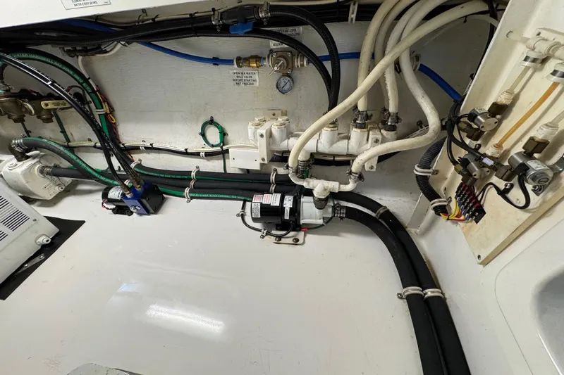 Regalo Yacht Photos Pics Engine room of 2013 Cabo 44 Hardtop Express with visible wiring and plumbing.
