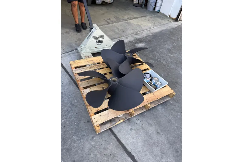 Regalo Yacht Photos Pics Propellers on a wooden pallet for 2013 Cabo 44 Hardtop Express boat.