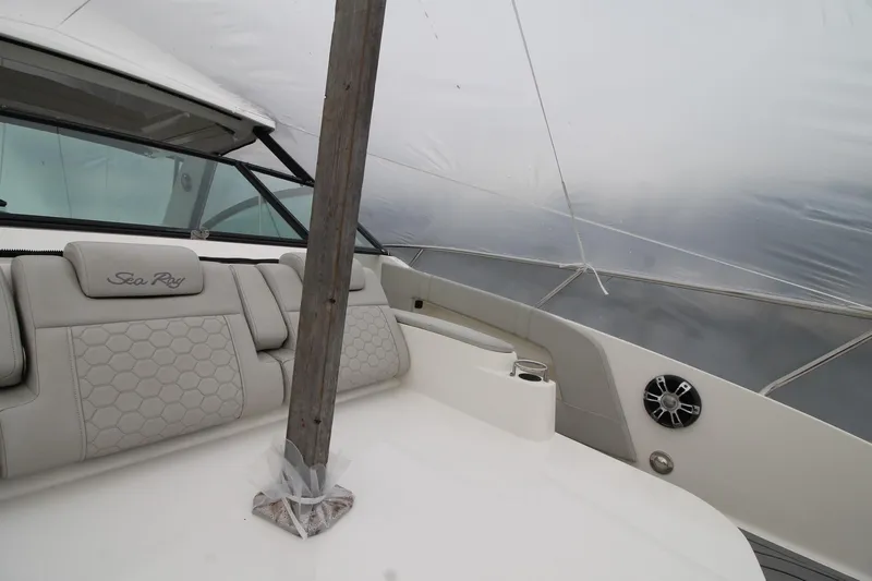  Yacht Photos Pics 2020 Sea Ray Sundancer 320 interior with cushioned seating and protective cover.