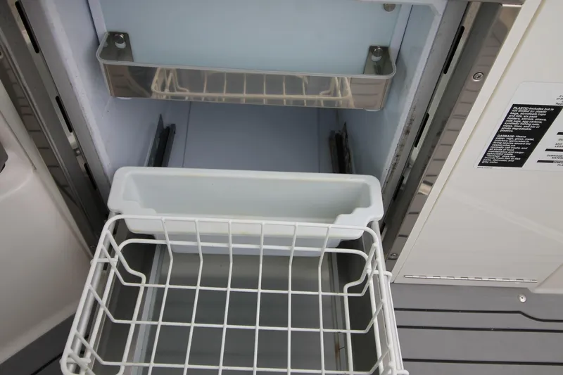  Yacht Photos Pics Open refrigerator drawer on 2020 Sea Ray Sundancer 320 boat, showcasing storage space.