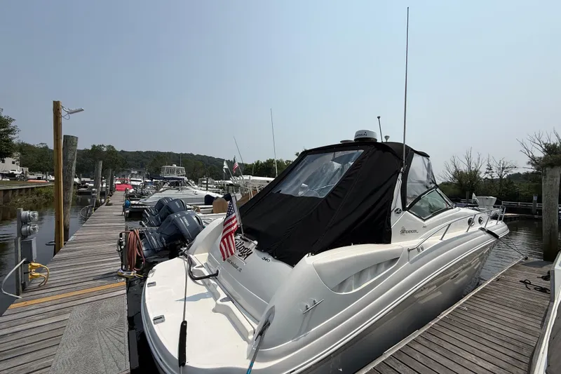  Yacht Photos Pics 2003 Sea Ray 340 Sundancer docked at a marina, featuring sleek design and American flag.