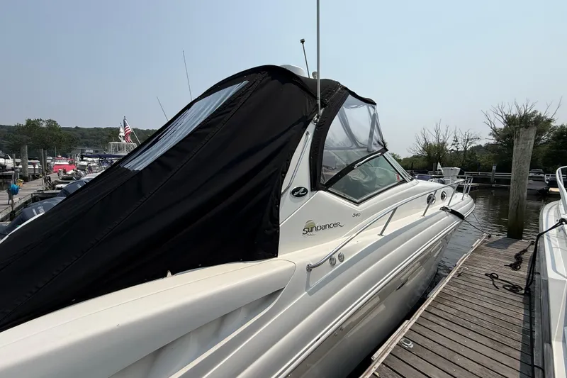  Yacht Photos Pics 2003 Sea Ray 340 Sundancer docked, featuring sleek design and black canopy.