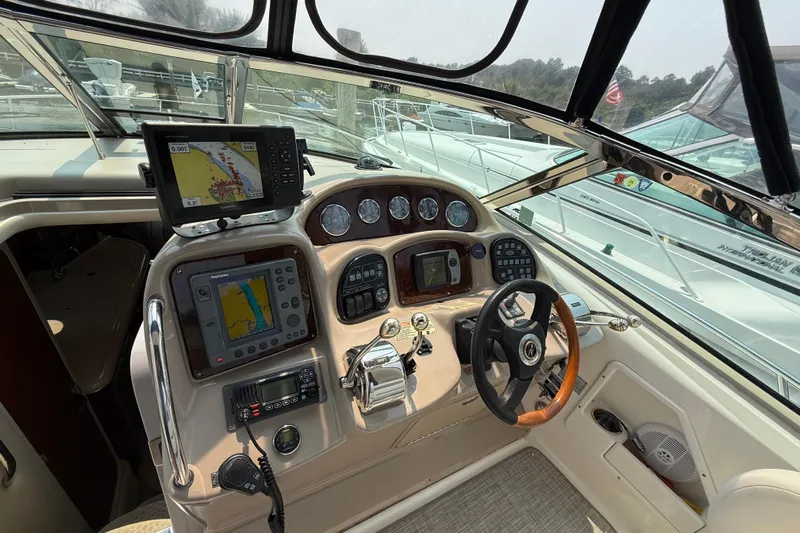  Yacht Photos Pics 2003 Sea Ray 340 Sundancer helm with navigation equipment and steering wheel.
