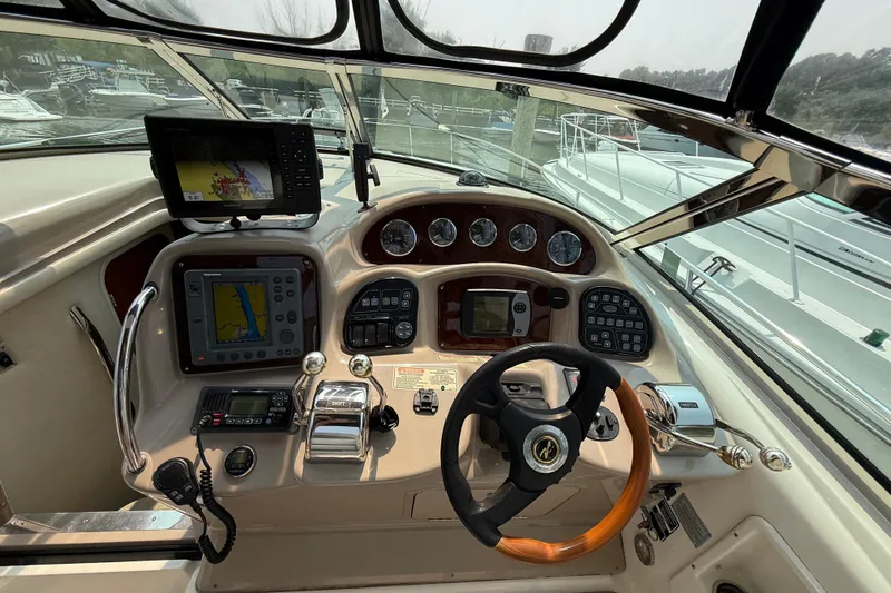  Yacht Photos Pics Helm of 2003 Sea Ray 340 Sundancer with navigation equipment and steering wheel.