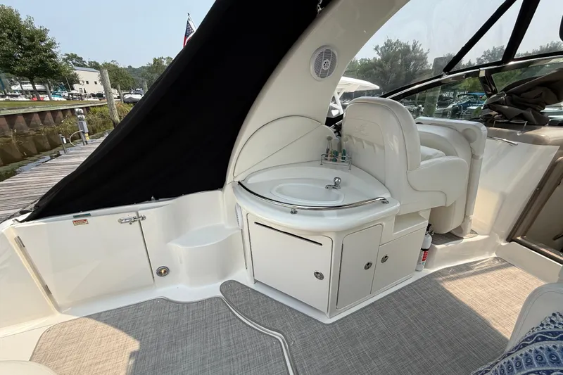  Yacht Photos Pics 2003 Sea Ray 340 Sundancer interior with sink and seating, docked at marina.