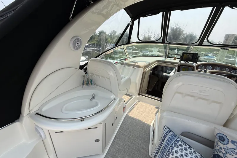  Yacht Photos Pics 2003 Sea Ray 340 Sundancer cockpit with helm, sink, and seating area.