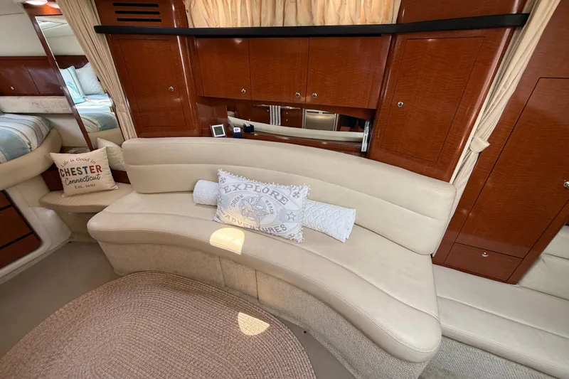  Yacht Photos Pics Luxurious interior of 2003 Sea Ray 340 Sundancer with curved seating and decorative pillows.
