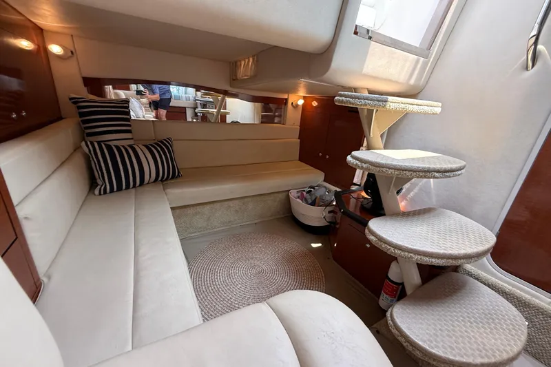  Yacht Photos Pics Interior of 2003 Sea Ray 340 Sundancer yacht with cozy seating and spiral staircase.