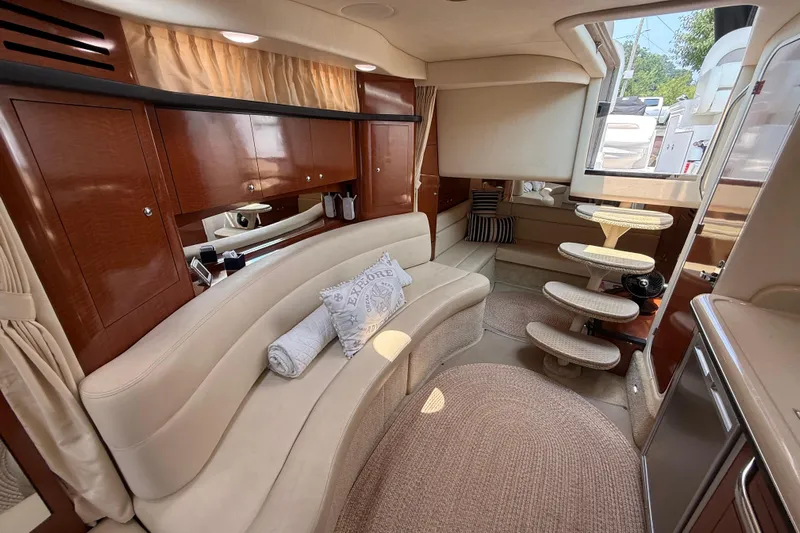  Yacht Photos Pics Luxurious interior of a 2003 Sea Ray 340 Sundancer yacht with elegant seating and wooden cabinetry.