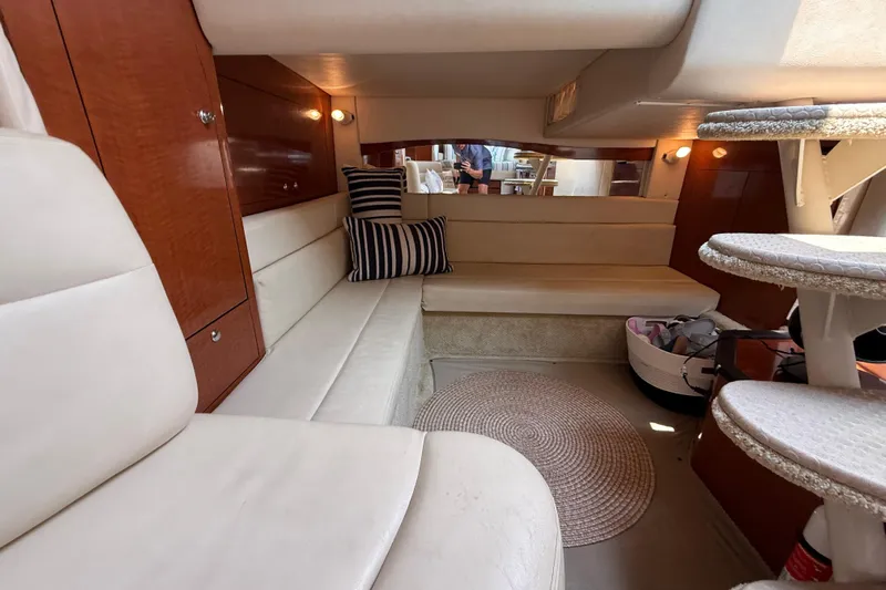  Yacht Photos Pics 2003 Sea Ray 340 Sundancer cabin interior with plush seating and elegant wood finishes.