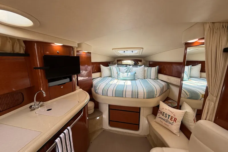  Yacht Photos Pics Luxurious interior of 2003 Sea Ray 340 Sundancer yacht with cozy bed and kitchenette.