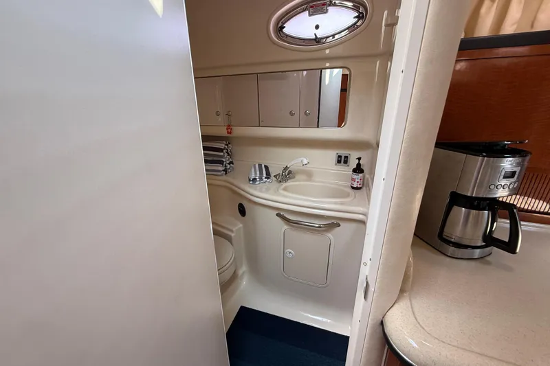  Yacht Photos Pics 2003 Sea Ray 340 Sundancer bathroom with sink, mirror, and coffee maker nearby.