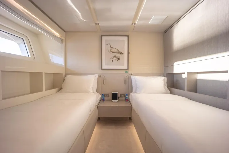 Phoenix Yacht Photos Pics Luxurious twin cabin interior on 2019 Sanlorenzo SD112 yacht, featuring elegant decor and natural light.