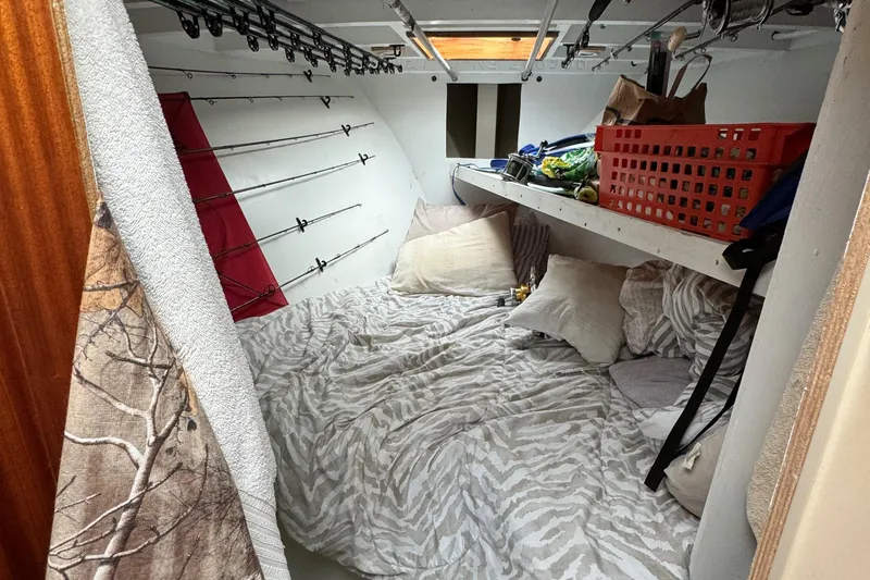 Thunder Yacht Photos Pics Cozy cabin interior of 1962 Custom Carolina 36 Warren O'Neal boat with fishing rods and bedding.