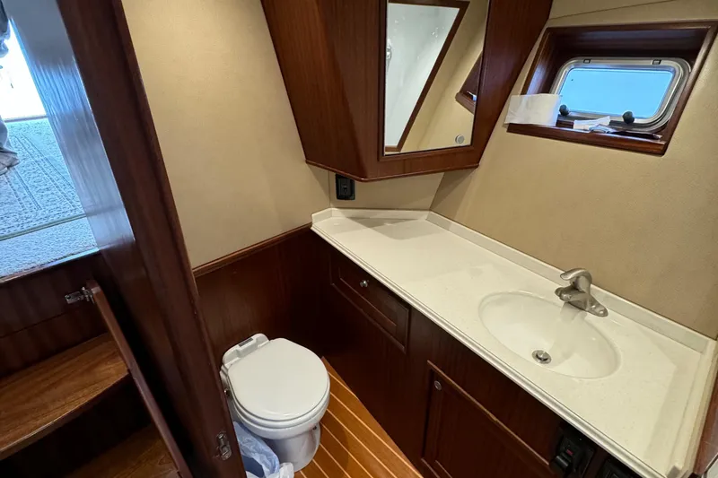 Thunder Yacht Photos Pics Luxurious bathroom in 1962 Custom Carolina 36 Warren O'Neal boat, featuring wood accents and modern fixtures.