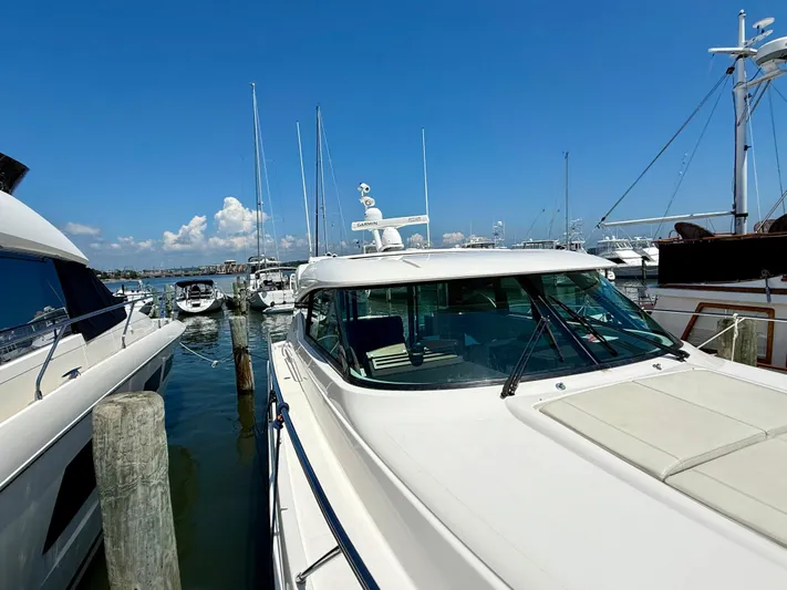  Yacht Photos Pics 2017 Tiara Yachts C44 Coupe docked at a marina under clear blue skies.