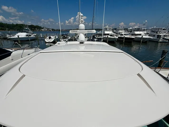  Yacht Photos Pics 2017 Tiara Yachts C44 Coupe docked at marina, surrounded by other boats.