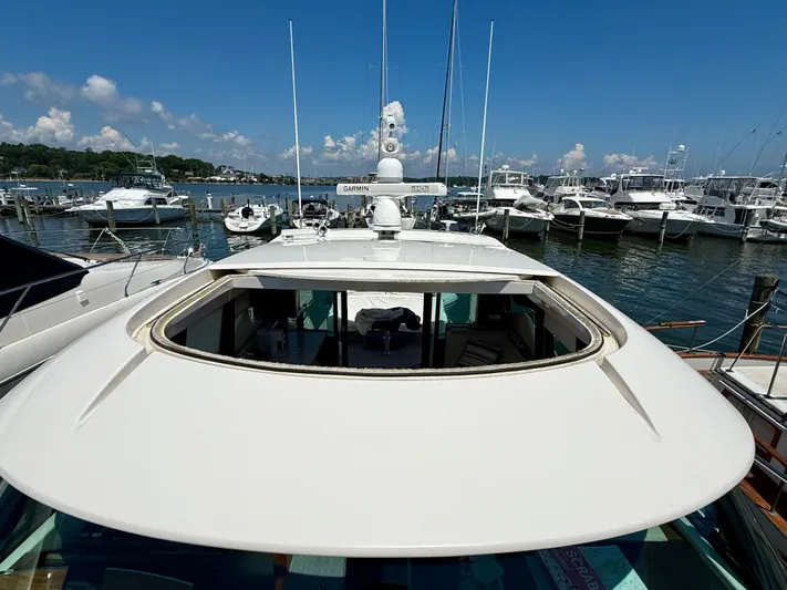 Yacht Photos Pics 2017 Tiara Yachts C44 Coupe docked at marina, showcasing open sunroof and sleek design.