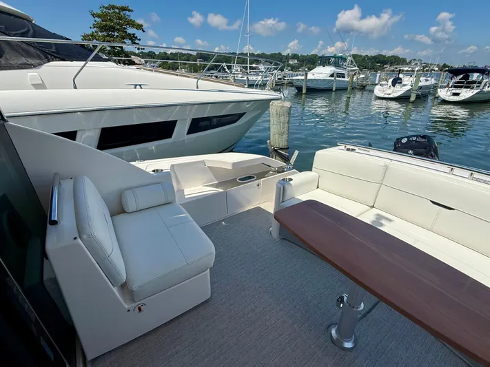  Yacht Photos Pics 2017 Tiara Yachts C44 Coupe with elegant seating at a marina.