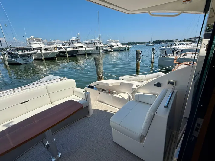  Yacht Photos Pics 2017 Tiara Yachts C44 Coupe interior with marina view, featuring comfortable seating and elegant design.