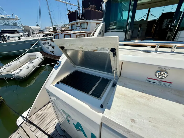  Yacht Photos Pics 2017 Tiara Yachts C44 Coupe with open grill on deck, docked at marina.