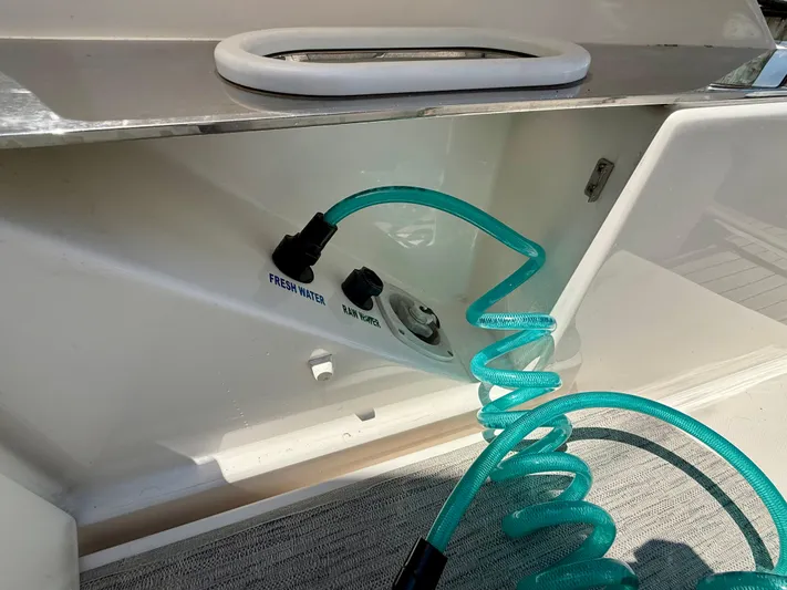  Yacht Photos Pics Freshwater and raw water connections on 2017 Tiara Yachts C44 Coupe with coiled hose.