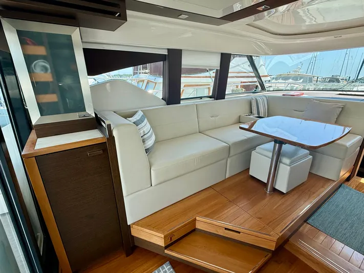  Yacht Photos Pics Luxurious interior of 2017 Tiara Yachts C44 Coupe with elegant seating and wooden accents.