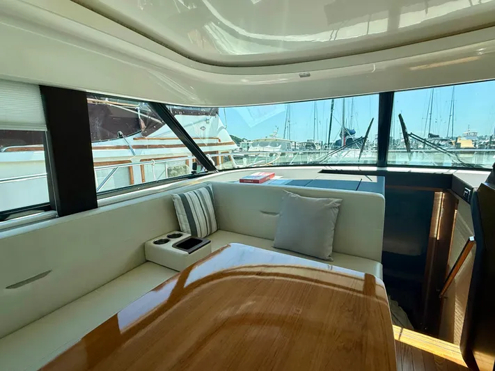  Yacht Photos Pics Interior of 2017 Tiara Yachts C44 Coupe with elegant seating and large windows.