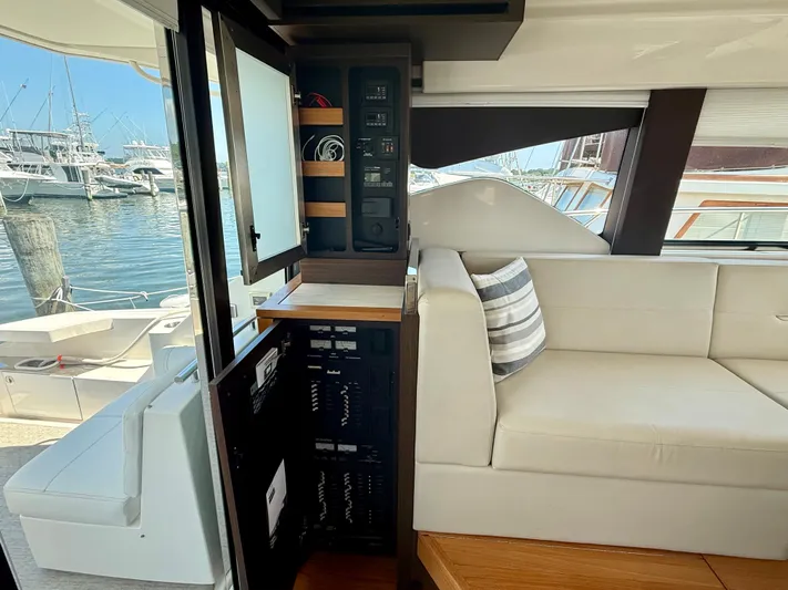  Yacht Photos Pics Interior of 2017 Tiara Yachts C44 Coupe, featuring control panel and comfortable seating.