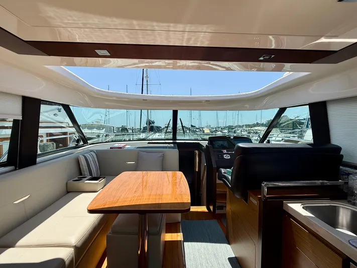  Yacht Photos Pics Interior of 2017 Tiara Yachts C44 Coupe with modern seating and helm.