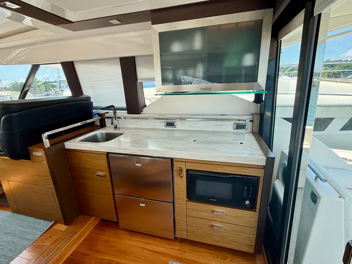  Yacht Photos Pics Luxurious 2017 Tiara Yachts C44 Coupe interior with modern kitchenette and sleek design.